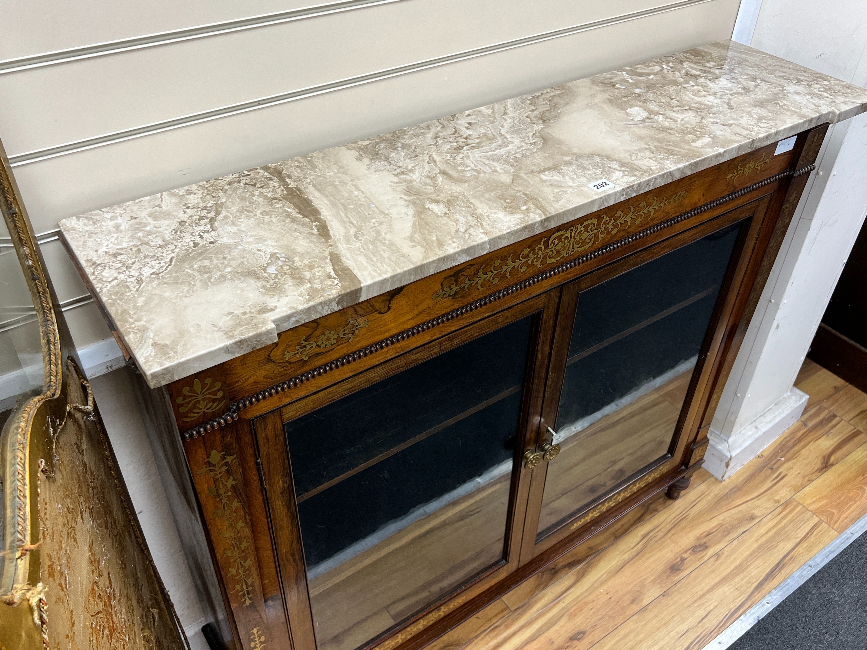A Regency brass inlaid rosewood marble topped side cabinet, width 121cm, depth 30cm, height 107cm